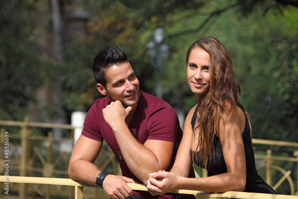 Young man looking to his girlfriend outdoor Young man looking to his girlfriend outdoor