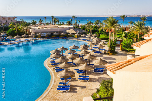 Fotografie, Obraz the pool, beach umbrellas and the Red Sea in Egypt