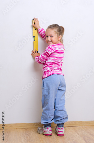 Little girl with measuring level