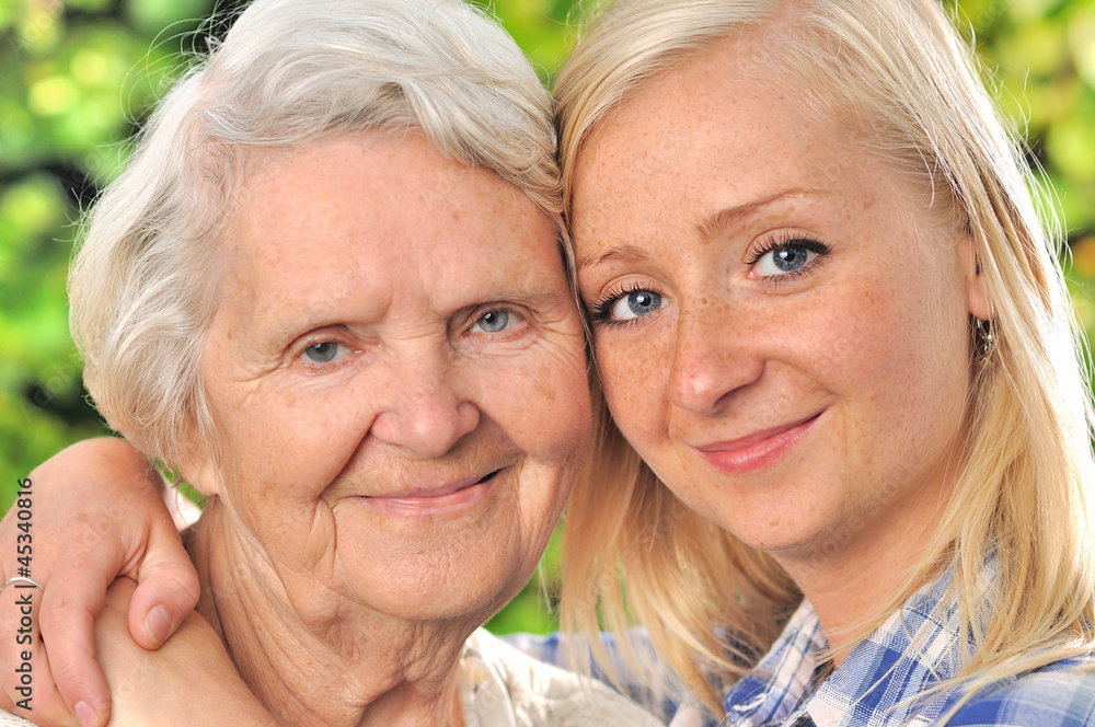Grandmother and granddaughter. Senior and young woman outdoors.
