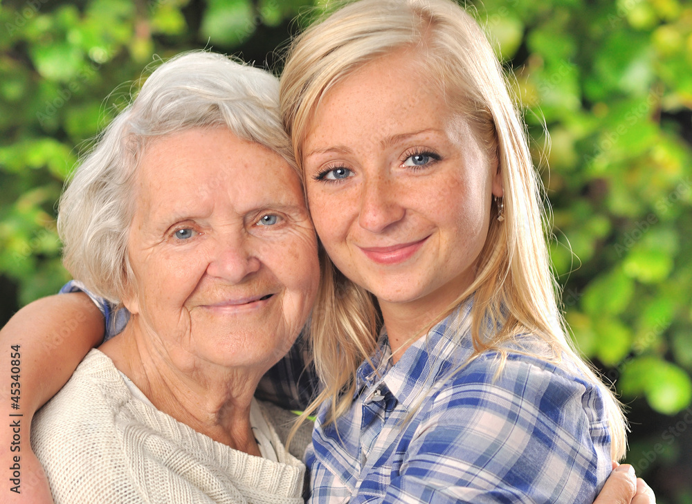 Grandmother and granddaughter. Senior and young woman outdoors.