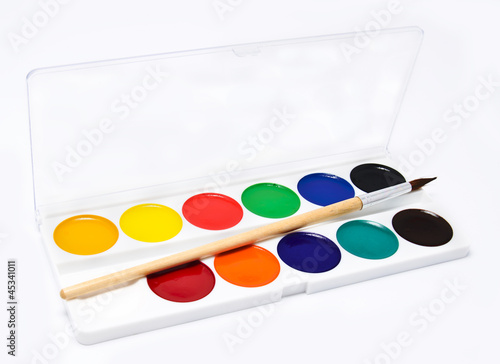 Paints and brush on a white