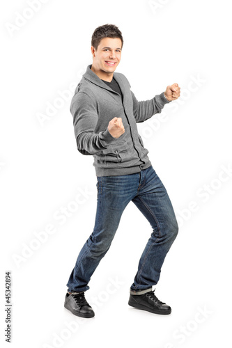 Full length portrait of a young male gesturing happiness