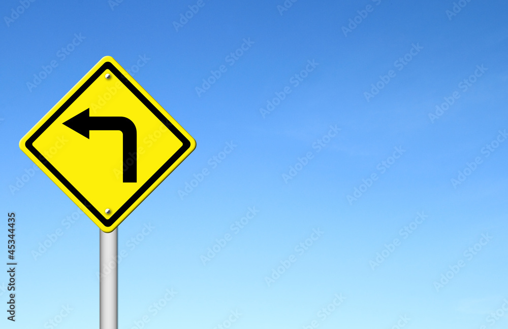 Road Sign - Left Turn Warning with blue sky Road Sign - Left Turn Warning with blue sky