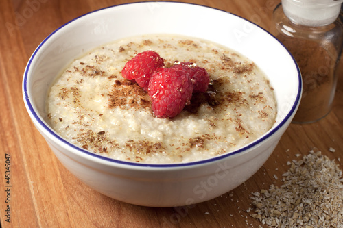 Healthy breakfast of hot oat bran cereal with yogurt and berries