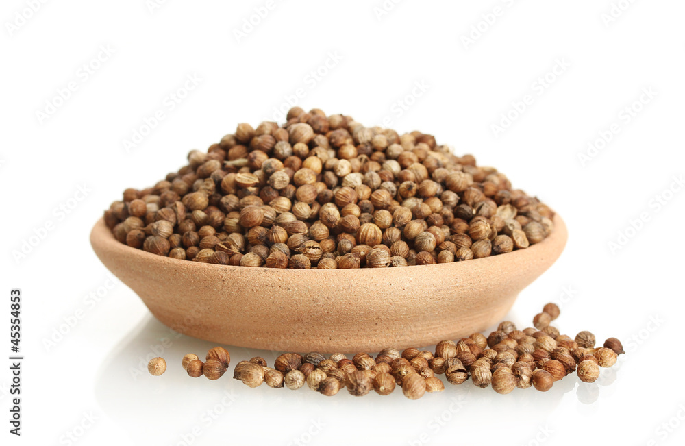 Heap coriander seeds in clay bowl isolated on white Heap coriander seeds in clay bowl isolated on white