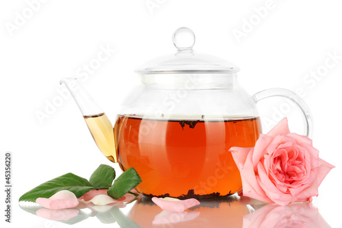 teapot of tea with rose isolated on white photo