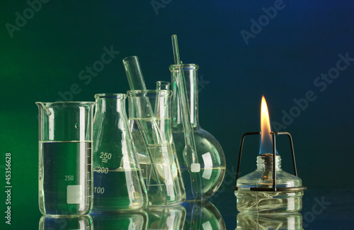 spiritlamp and test-tubes on  blue-green background photo