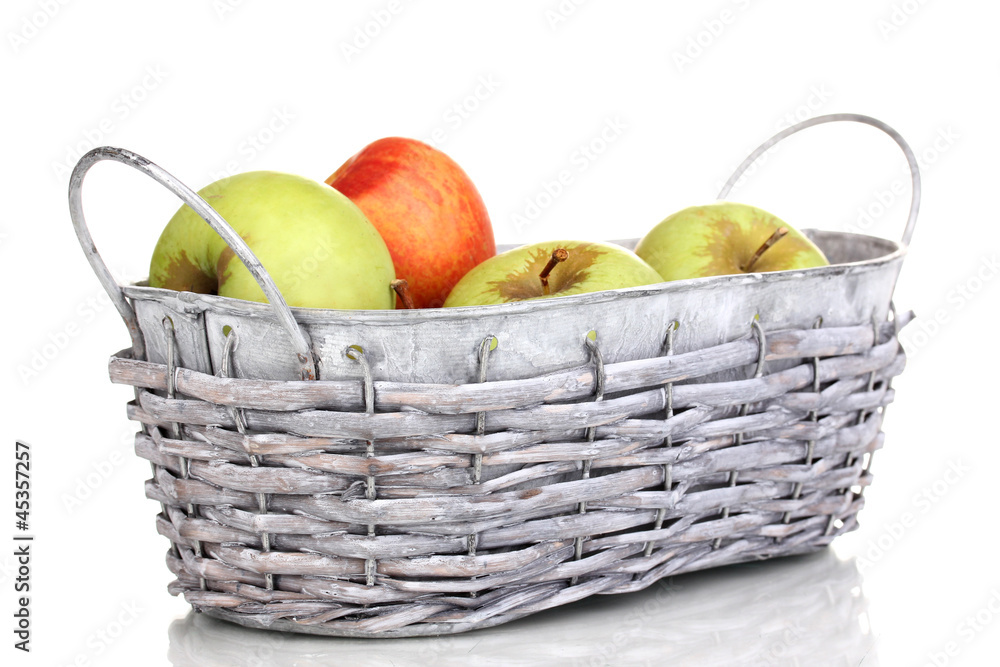 Ripe apples in basket isolated on white