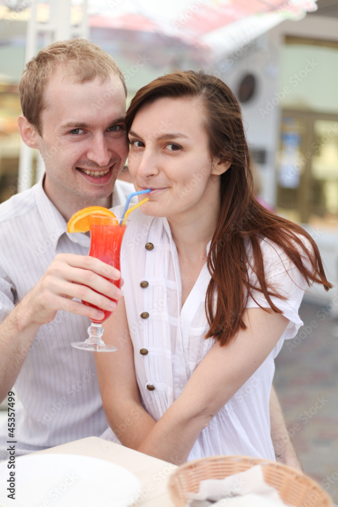 Young couple drinking juice in cafe Young couple drinking juice in cafe