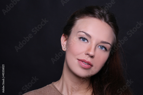 Beautiful young woman in dark background