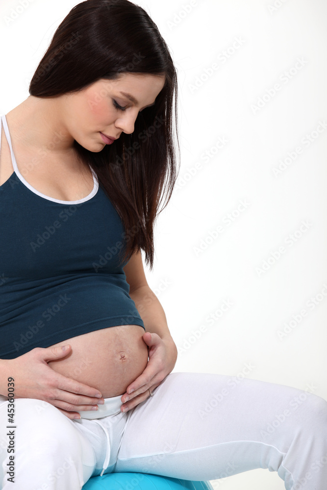 pregnant woman touching her stomach pregnant woman touching her stomach