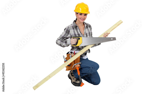 A female carpenter with a handsaw. © auremar