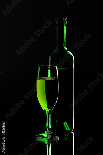 Still-life with special green wine bottles and glass
