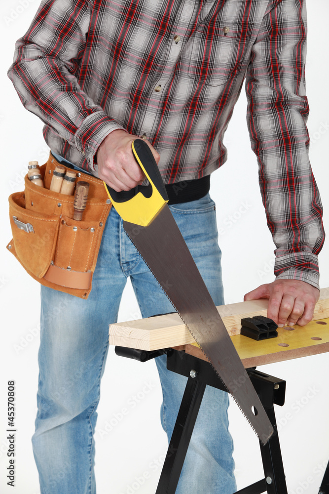 closeup on tradesman handling saw closeup on tradesman handling saw