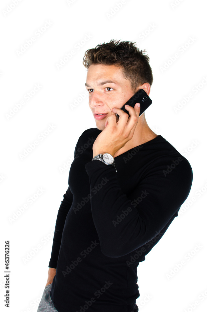 Young man with cell phone standing against white background Young man with cell phone standing against white background