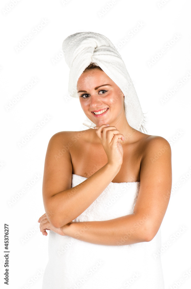 Portrait of young woman after bath brushing her teeth Portrait of young woman after bath brushing her teeth