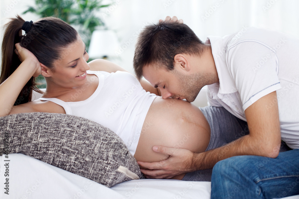 Future dad kissing his unborn baby Future dad kissing his unborn baby