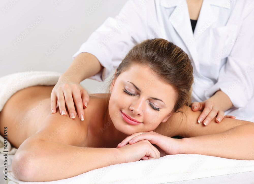 Closeup of an attractive young woman receiving massage Closeup of an attractive young woman receiving massage