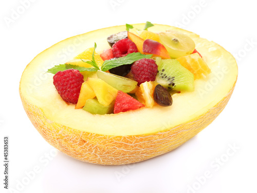 fresh fruits salad in melon, isolated on white