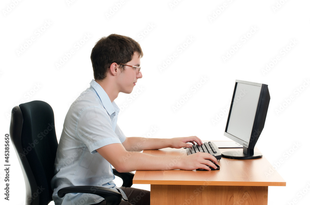 The businessman behind a table with the computer The businessman behind a table with the computer