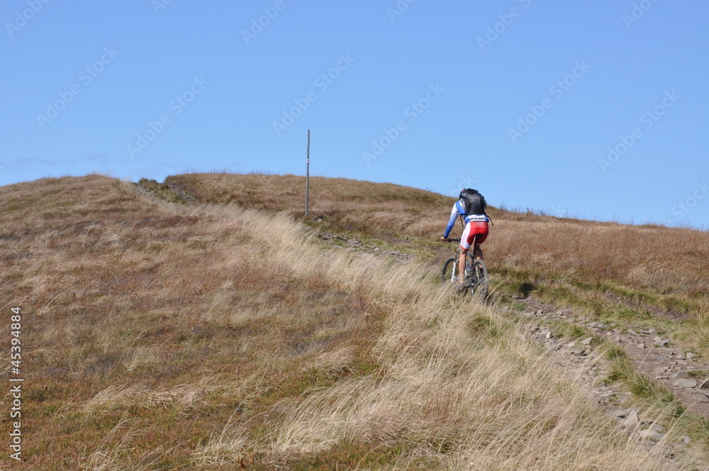 A man riding uphill on a mountain bike