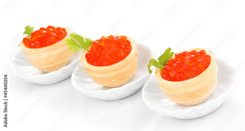 Red caviar in tartlets on little white saucers isolated on Red caviar in tartlets on little white saucers isolated on