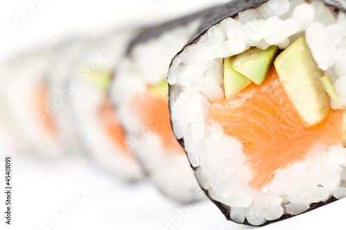 Row of prepared maki sushi rolls, isolated on white