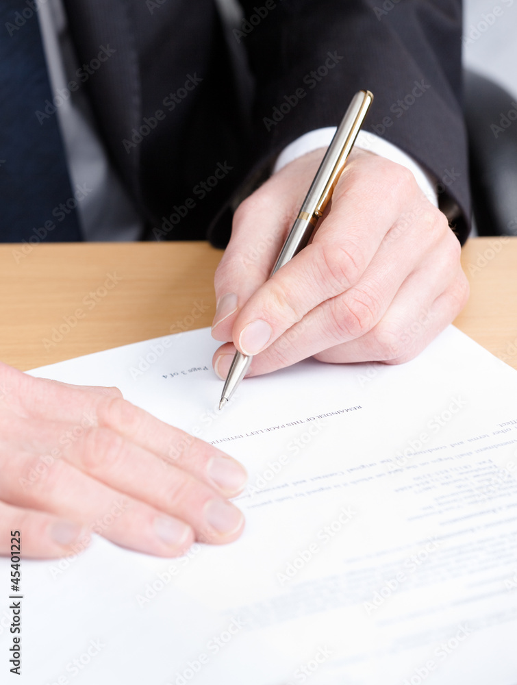 Business man making notes in the writing pad Business man making notes in the writing pad