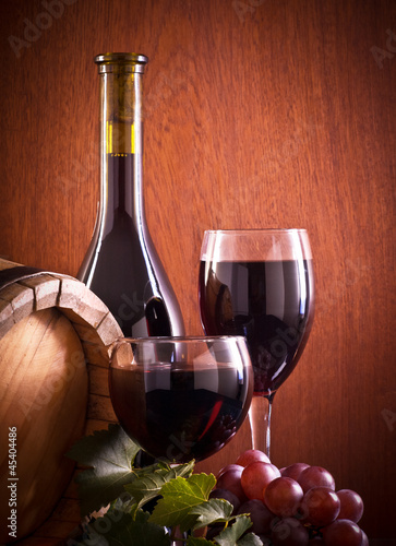 Red wine glass and Bottle on a wooden background