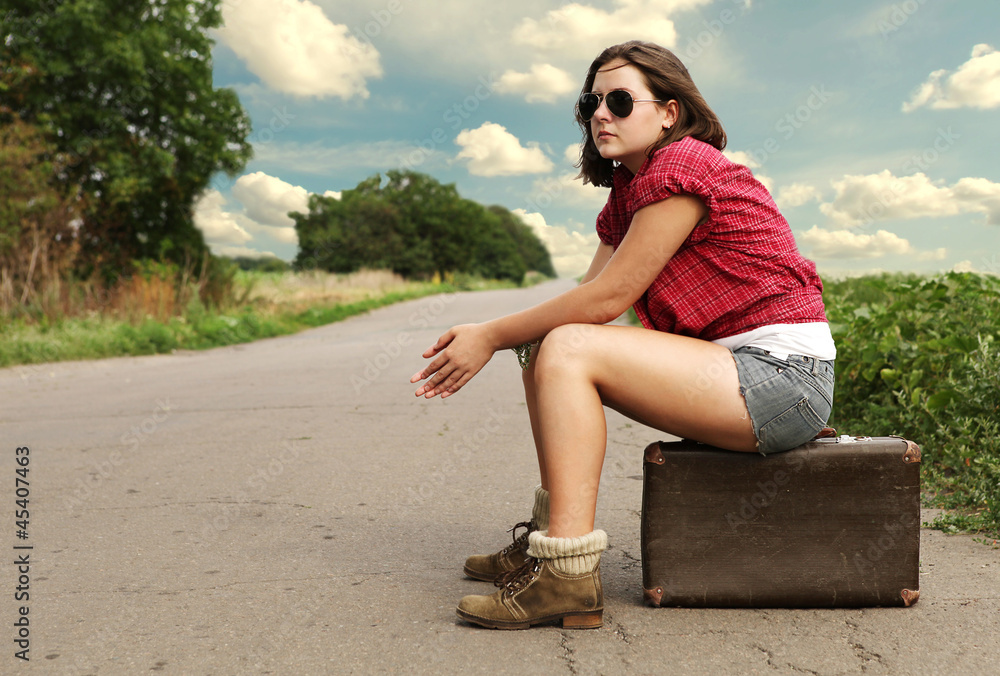 Young girl traveler on the lonely road Young girl traveler on the lonely road