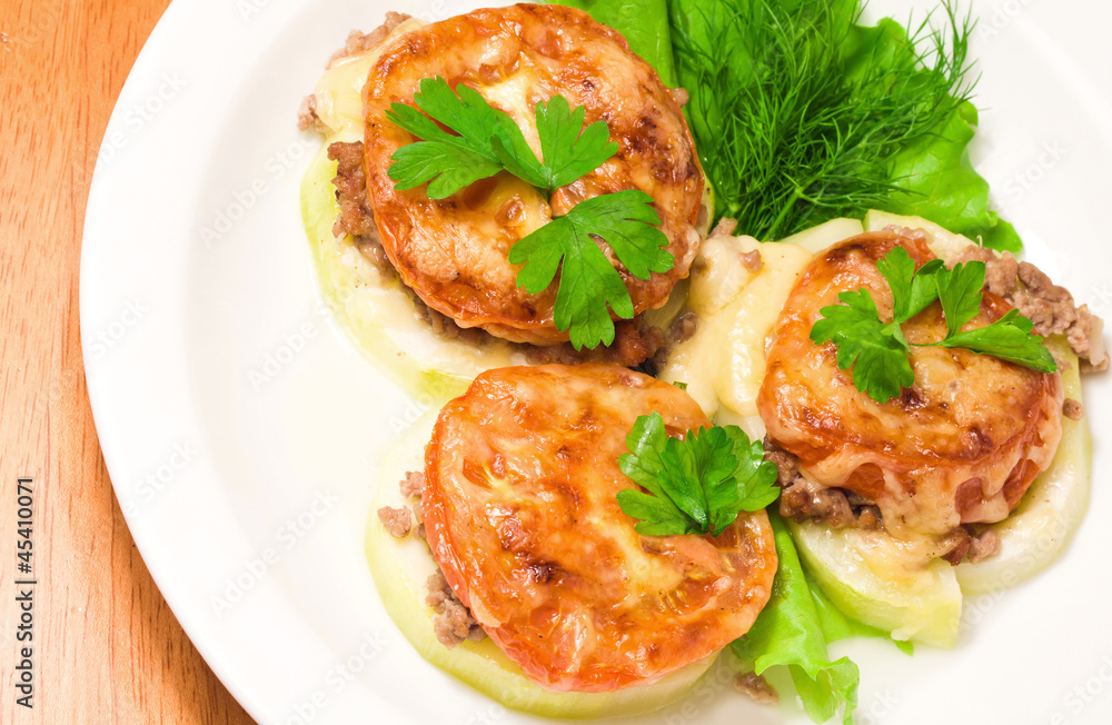 Backed vegetable marrow stuffed with meat, tomato, cheese and gr Backed vegetable marrow stuffed with meat, tomato, cheese and gr