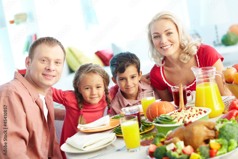 Family by festive table Family by festive table