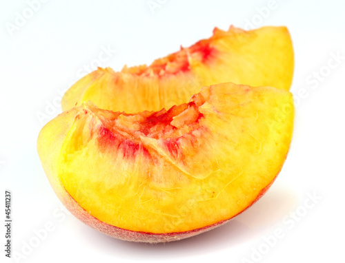Slices of peach on white background
