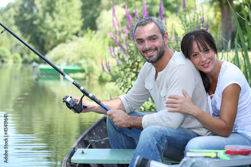 Couple sitting in a boat fishing
