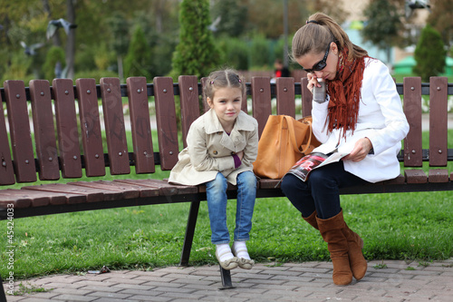 mother and little girl in autumn park