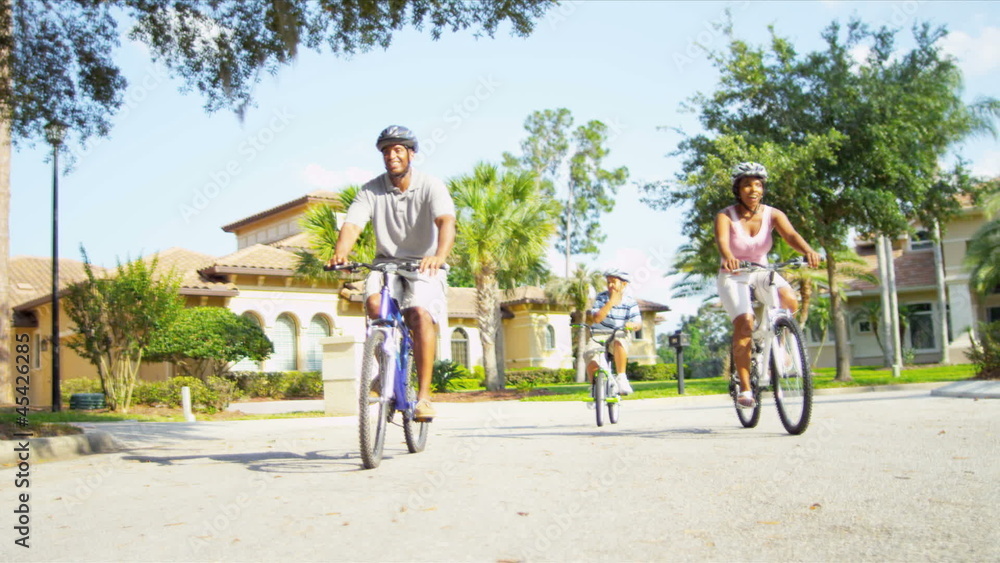 Young Ethnic Family Cycling Together Young Ethnic Family Cycling Together