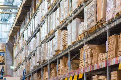 Rows of shelves with boxes in modern warehouse