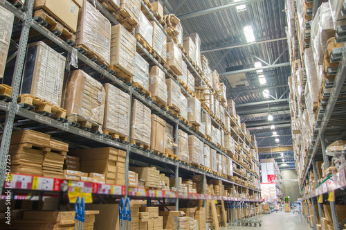 Rows of shelves with boxes in modern warehouse