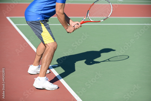 Tennis Player and Shadow on Court
