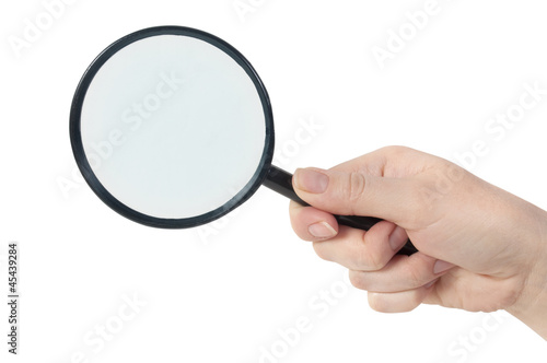 Magnifying glass in hand isolated on white background