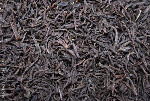 Black leaves tea background, food ingredient texture
