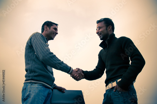 Shaking hand of indian young happy people