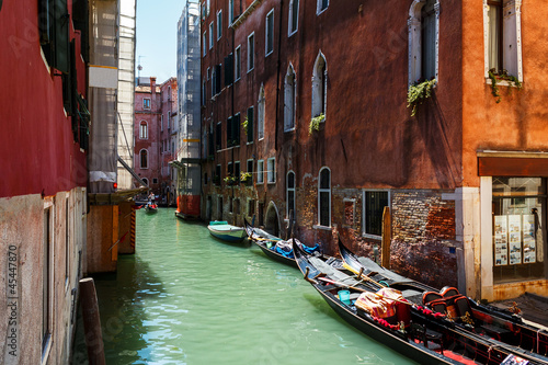 Venice canal with boats and gondolier