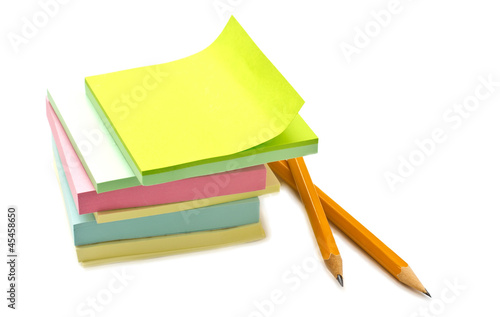 Multicolored stickers and pencils isolated on white photo