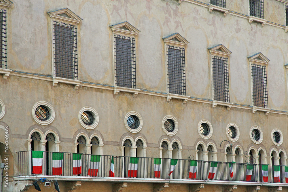 medieval palace with Italian tricolor flags in vicenza in italy