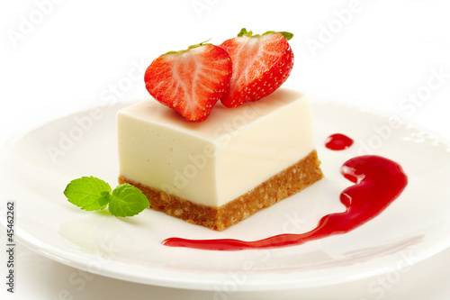 cheesecake with strawberries on white plate