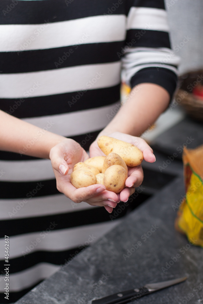 Frau hält Kartoffeln in ihren Händen