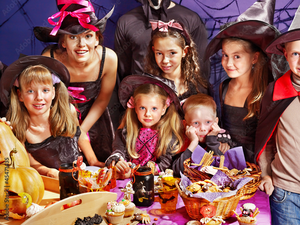 Children on Halloween party making pumpkin Children on Halloween party making pumpkin