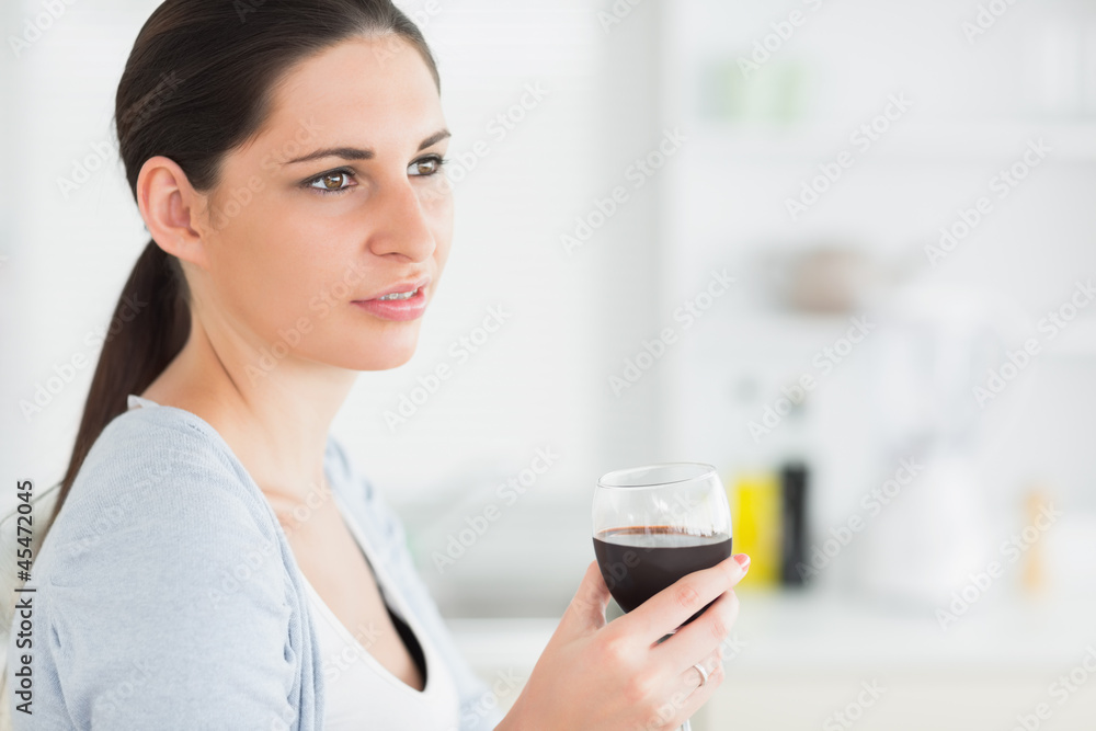 Brunette holding a red wine glass Brunette holding a red wine glass
